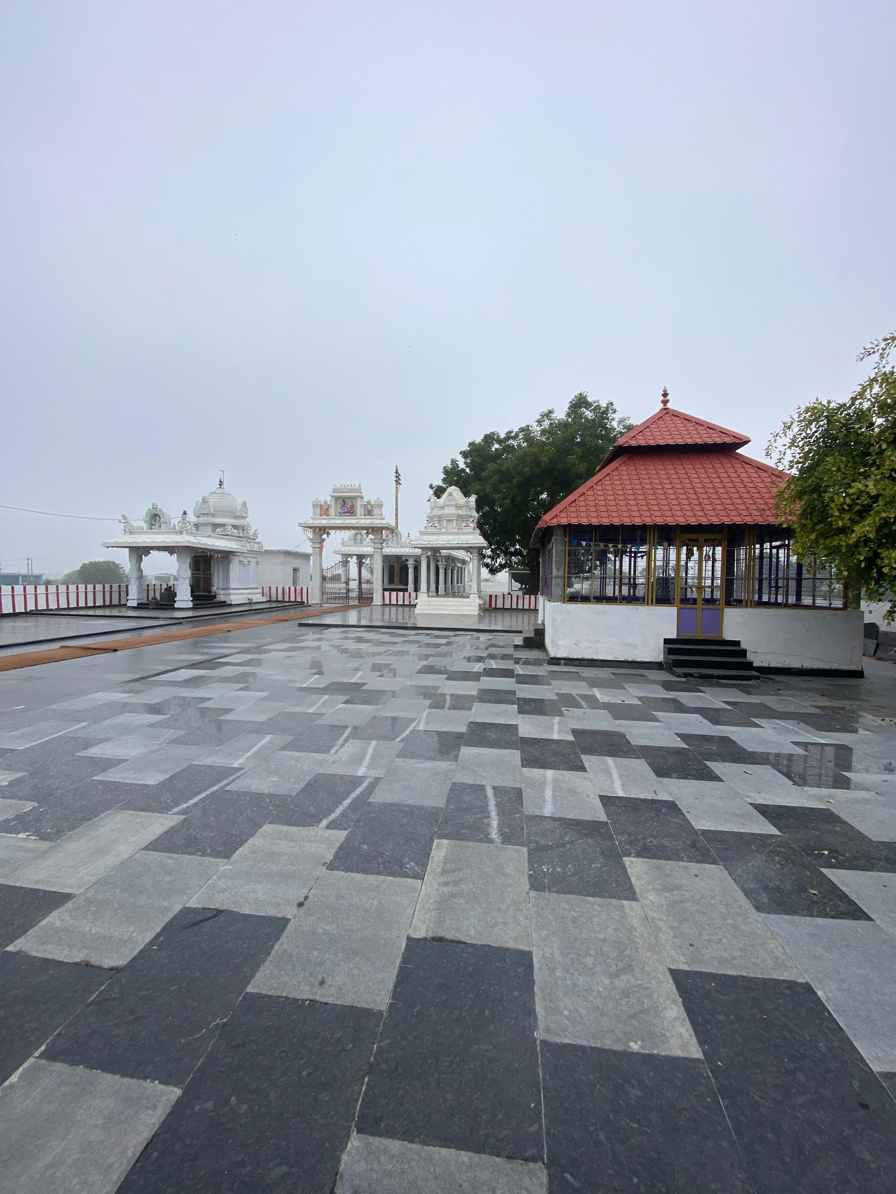 Temple complex with white gopurams and marble flooring